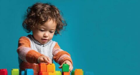 a-cheerful-toddler-builds-with-colorful-blocks-enjoying-creative-playtime-and-learning-photo